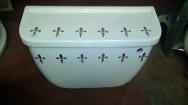 gold fleur de lis on white cistern